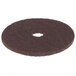A brown Scrubble floor pad with a hole in the middle.