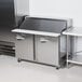 A Traulsen stainless steel commercial sandwich prep refrigerator with right hinged doors.