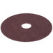 A brown Scrubble conditioning floor pad with a hole in the middle.