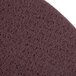 A close-up of a maroon Scrubble floor pad with a purple texture.