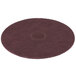 A close-up of a maroon circular Scrubble conditioning floor pad.