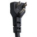 A black power cord plug with a metal tip on a Traulsen UPT7218-RR.