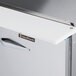 The right hinged stainless steel door of a Traulsen refrigerated sandwich prep table.