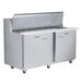 A Traulsen stainless steel sandwich prep table with two left hinged doors and two right hinged doors.