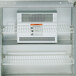 A white powder-coated metal wire rack shelf for a Traulsen refrigerator.