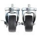 A pair of Traulsen swivel casters with black rubber wheels and nuts on them.