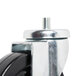 A Traulsen swivel stem caster with a black and metal wheel.