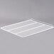 A white metal grid shelf for Traulsen refrigerators and freezers.