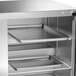 A white powder coated metal shelf for a Traulsen refrigerator and freezer.