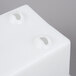 A white square storage holder with two holes.