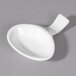 A white porcelain small spoon with a handle in a white bowl.