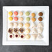 A white rectangular porcelain platter with assorted pastries on it.