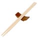 A pair of Town wooden chopsticks on a wood stand with a cross.