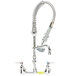 A silver T&S EasyInstall wall mounted pre-rinse faucet with a hose and sprayer.