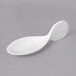 A white 10 Strawberry Street Whittier porcelain spoon on a gray surface.