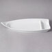 A white porcelain sushi boat with a curved edge.