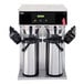 A Curtis D1000GT12A000 twin airpot coffee brewer on a counter with two cups.