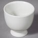 A close up of a 10 Strawberry Street Whittier white porcelain sake cup with a handle.