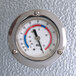 A close-up of a temperature gauge on a metal surface.