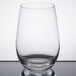 A clear Stolzle stemless wine glass on a reflective surface.