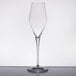A clear Stolzle Quatrophil wine flute on a reflective surface.