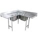 An Advance Tabco stainless steel corner sink with two drainboards and three compartments.