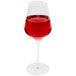 A Stolzle Quatrophil wine glass filled with red liquid.