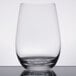 A close up of a clear Stolzle stemless wine glass on a table.