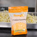A case of Sunglo Buttery Popcorn Salt seasoning bags on a counter.