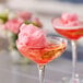 A pair of martini glasses filled with pink cotton candy floss sugar.