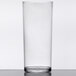 A clear plastic highball glass on a table.