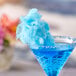 A blue drink with a blue cotton candy floss sugar rim.