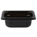 A black rectangular Vollrath plastic food pan with a white border.