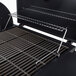 A Backyard Pro portable outdoor gas and charcoal grill with a rack on it.