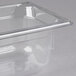 A clear plastic Vollrath 1/4 size food pan.