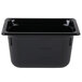A Vollrath black polycarbonate food pan on a counter.