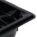 A black Vollrath polycarbonate food pan on a counter.