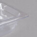 A Vollrath clear polycarbonate food pan with a clear lid on a counter.