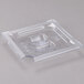 A Vollrath clear plastic slotted lid on a clear plastic food pan.