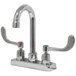 A chrome Advance Tabco deck-mount faucet with gooseneck and wrist handles.