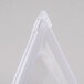 A close up of a clear plastic triangle lid.