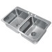 A stainless steel Advance Tabco double sink with two bowls.