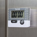 A Taylor digital kitchen timer on a metal surface.