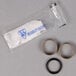 A T&S swivel repair kit with several black rubber rings and a white rubber seal.