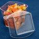 A plastic container with a clear dome lid containing food.