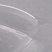 A clear plastic Fineline Tiny Tumbler dome lid on a clear plastic container.