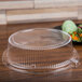 A Fineline clear plastic container with a lid on a table.