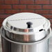 A Vollrath stainless steel hinged cover on a metal container.