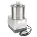 A silver and black Robot Coupe commercial food processor with a cord.