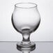 A close up of a Libbey Belgian beer tasting glass on a reflective surface.